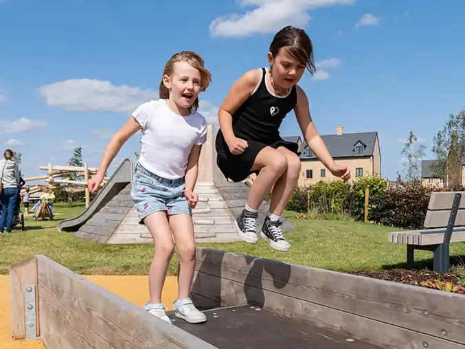Girls jumping on a wheelchair seesaw