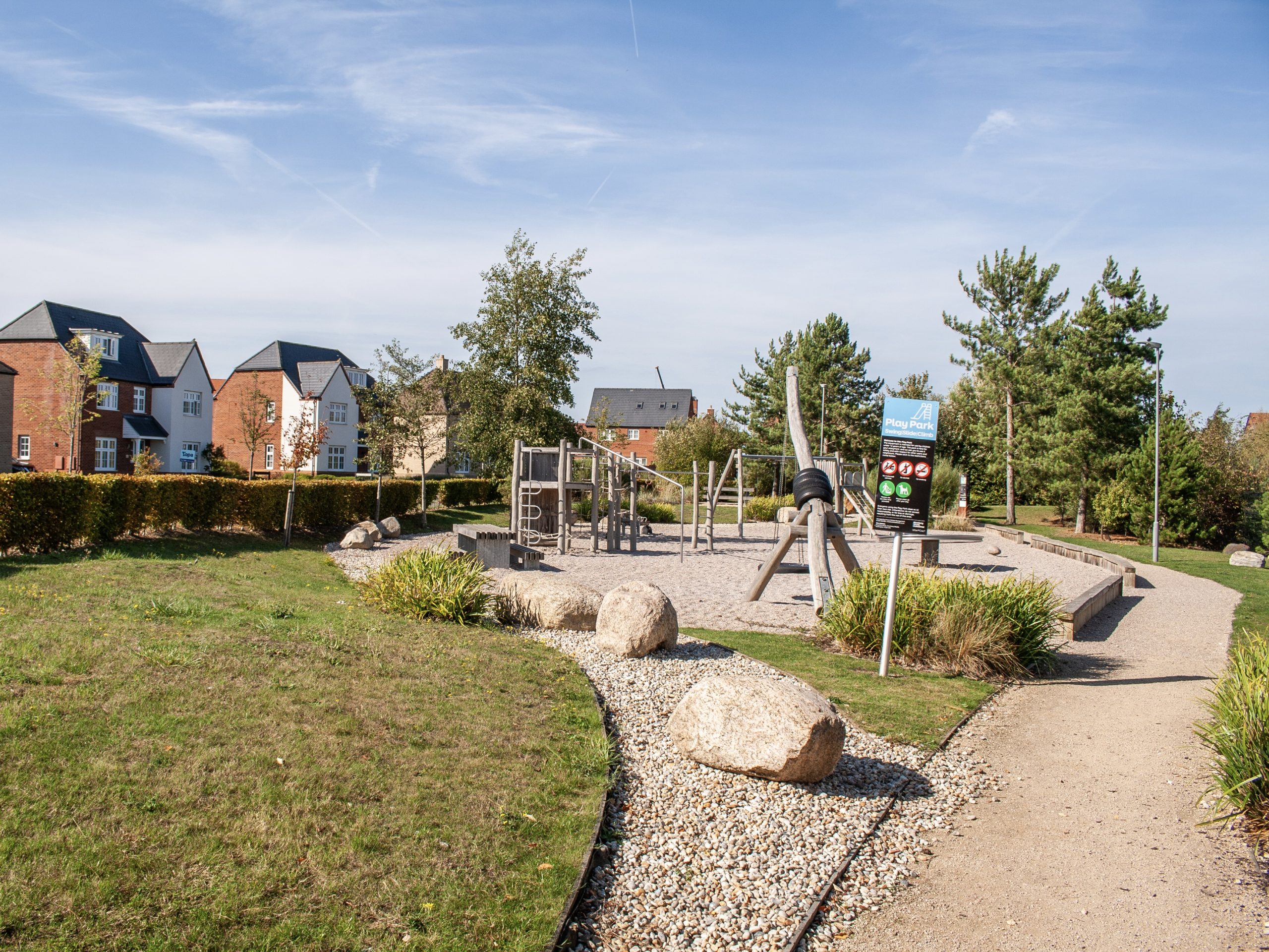 A playground with homes in the background.